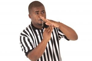 Black referee calling time out or a technical foul