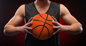 Close up of male basketball athlete gripping the ball