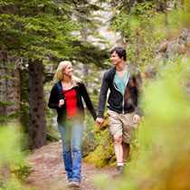 Male and female walking on wooded trail