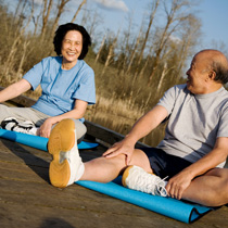 Asian couple sitting on yoga mats