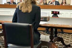 Katie Hoff sitting at a table before the before the U.S. House of Representatives Labor-HHS Appropriations Subcommittee about the critical need for blood clot awareness and education funding.