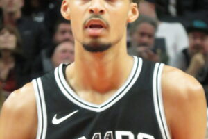 Victor Wembanyama of the San Antonio Spurs standing on the court during an NBA game in 2024.