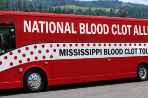 National Blood Clot Alliance red and white polka dot bus parked in Mississippi