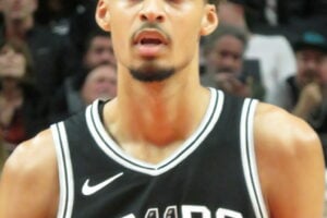 Victor Wembanyama of the San Antonio Spurs standing on the court during an NBA game in 2024.